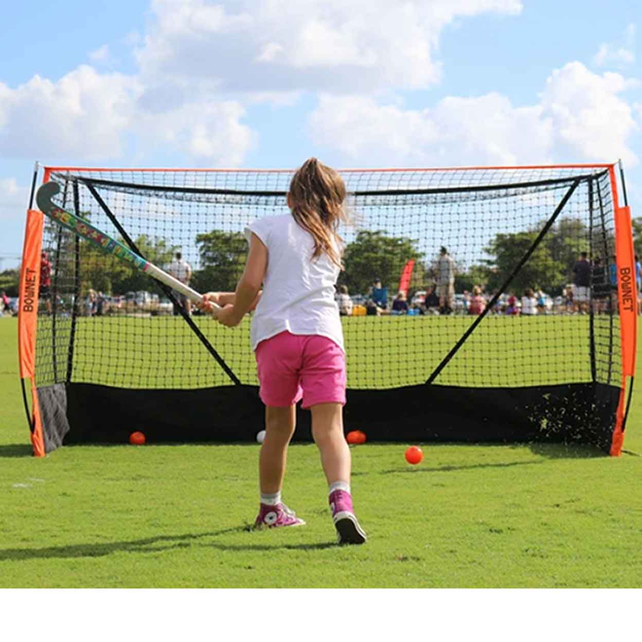 young girl practicing with the Bownet Youth Field Hockey Net