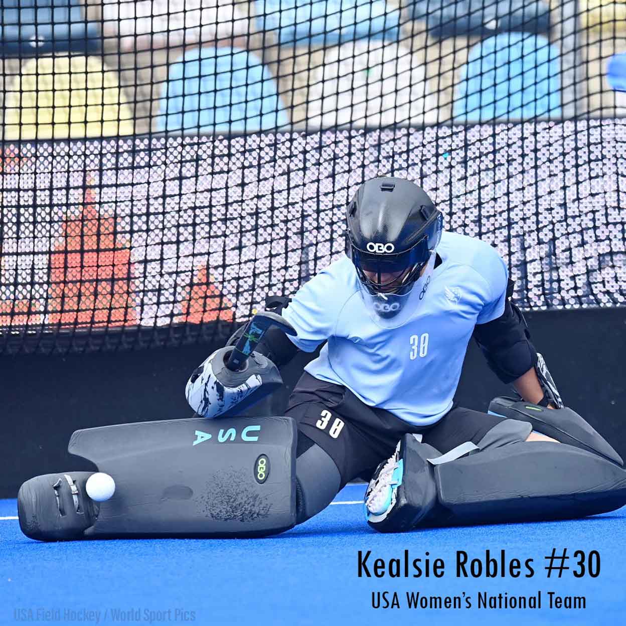 Field hockey goalie blocking the ball using OBO Robo Plus Legguards