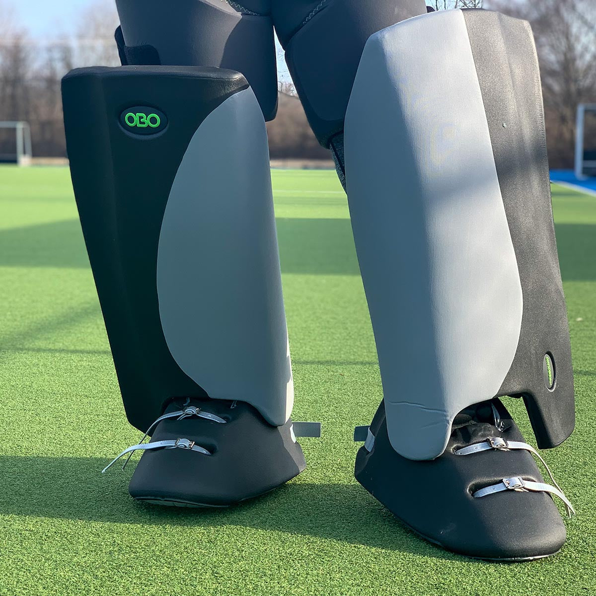 model wearing black and gray OBO Robo Hi-Rebound Field Hockey Goalkeeping Legguards